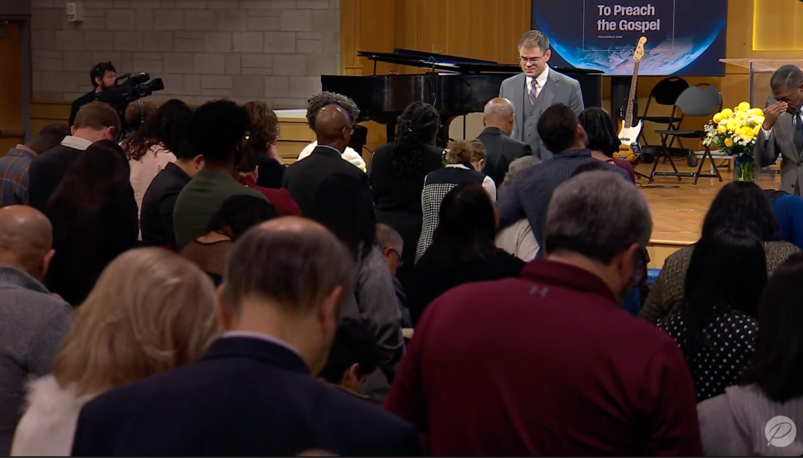 PMC lead pastor Shane Anderson leads prayer following the service.